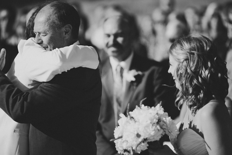 father of the bride hugging groom